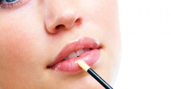 applying lip gloss