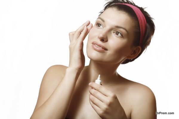A woman uses a cream. Caring for mature skin.