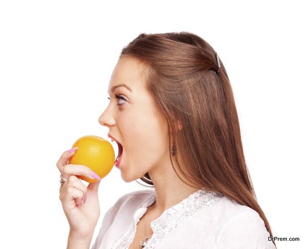 YOung woman eating orange