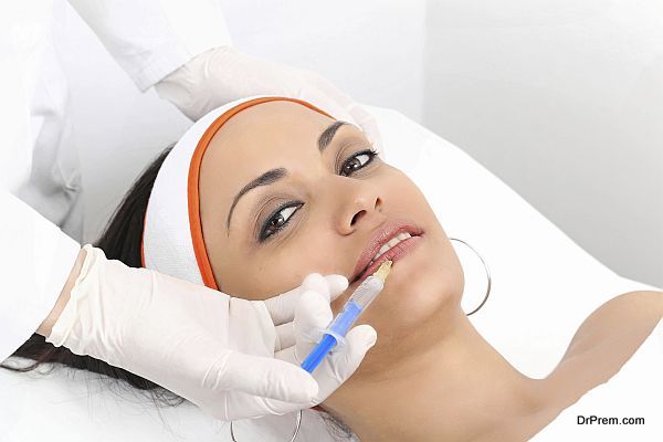 Young woman having lip augmentation at beauty clinic