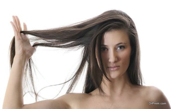 Young attractive woman playing with her natural long hair
