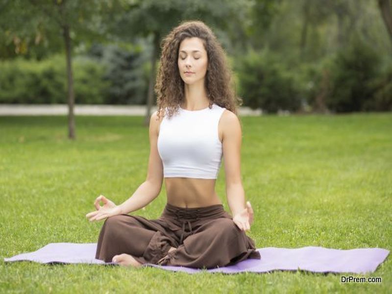 Pretty woman doing yoga exercises