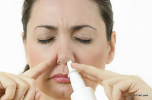 woman using nasal spray