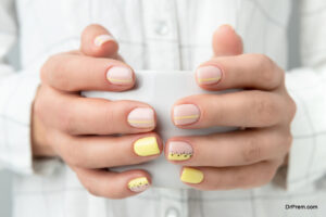 Manicured woman's hands holding a cup of coffee